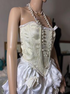 Handmade renaissance style corset.  DM for custom sizing and fabrics. Corset laced at back with gold grommets and thick cream satin ribbon.  Straps can be worn on or off shoulders, and can be completely removed. Straps not shown.  Made with sustainably sourced and re-purposed fabrics.  Boned with mixture of heavy flat steel and German synthetic boning. Corset  Sizes:  Waist: 24  - 28" Bust: 30" - 35" Corset Wedding Dress Green Ribbon, Historical Underbust Corset Dress For Wedding, Victorian Underbust Wedding Bodice, Wedding Underbust Corset Dress With Historical Design, Elegant Lace Bodice With Corset Back, Elegant Underbust Bodice For Costume, Elegant Fitted Lace Trim Bodice, Elegant Underbust Corset With Lace Trim, Lace Fitted Underbust Bodice