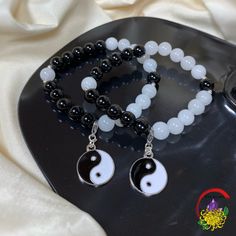 This includes (2) matching bracelets with 8mm round Black Obsidian and White Jade Beads, and a Stainless Steel Detachable Lobster Claw Yin and Yang Charm. Yin and Yang is a Chinese philosophical concept meaning duality, bringing harmony between two opposite characteristics as they complement one another. These bracelets can bring positivity while fighting off any negative energy. They can also help to give strength, peace, and balance. Every bead is handpicked with love and care to ensure you will receive only the highest and best quality beads on your bracelet. All of the beads are all natural and high quality, and do not include any glass, plastic, dye, or resin.   Black Obsidian is a powerful stone that will cleanse your life from any negative energy and people. This stone is a strong p Long Distance Bracelets, Yin Yang Charm, Peace And Balance, Distance Bracelets, Rutilated Quartz Crystal, Crystal Bangle, Moonstone Crystal, Yin And Yang, Crystal Beads Bracelet