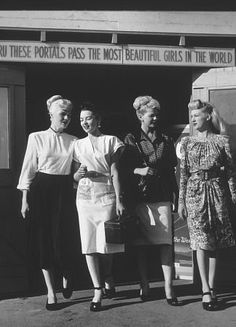 four women standing in front of a building