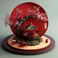 a red paper sculpture with a tree and building in the middle, surrounded by rocks