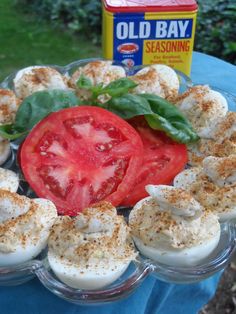 an old bay seasoning tomato and mozzarella appetizer on a blue cloth