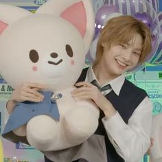 a person holding a large stuffed animal in their hands