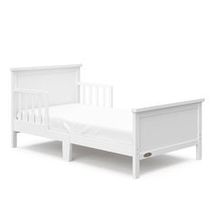 a small white bed with no sheets on the bottom and side rails, against a white background