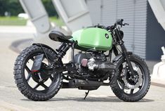 a green and black motorcycle parked on the street