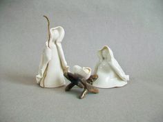 two figurines sitting next to each other on a table