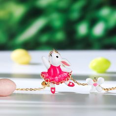 How cute is this pink bunny rabbit necklace accented with cultured pearls and white enamel flowers? Spring is in the air every day with this beautiful necklace, perfect for Easter gifting and hand enamelled, set on an gold plated sterling silver necklace. The ideal accessory to kick off your Spring, Summer look.Carat Weight: 1.5 ctStone Size: 6 mmNumber of Stones: 1 Stone Color: Diamond WhiteStone Shape: RoundWeight: 4.9 gWidth: 16 mmHeight: 23 mmThickness: 7.7 mmPlating Color: Yellow GoldLength Pink Jewelry For Easter Gift, Playful Pink Jewelry For Easter, Easter Bunny Design Jewelry Gift, Rabbit Necklace, Spring Is In The Air, Pink Bunny, Flowers Spring, Enamel Flower, Necklace Online