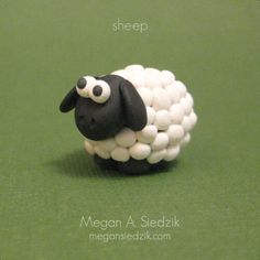 a sheep made out of marshmallows sitting on top of a green surface