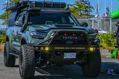 a green toyota truck parked in a parking lot