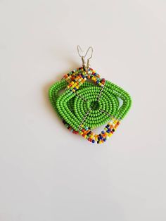 This listing is for ALL 11 pairs like shown above. The earrings are 100% handmade using original fine beads. Colorful and bright colors. ^^These earrings ships through dhl express. More earrings; https://www.etsy.com/shop/TribalTess?ref=seller-platform-mcnav&section_id=21293980 Buy multiple items and pay shipping for ONE item ONLY. Green Beaded Earrings With Large Beads For Gift, Unique Green Beaded Earrings, Unique Green Earrings With Colorful Beads, Traditional Green Beaded Earrings With Tiny Beads, Traditional Green Earrings With Tiny Beads, Traditional Multicolor Earrings With Spacer Beads, Traditional Green Beaded Earrings With Large Beads, African Jewelry Earrings, African Earrings