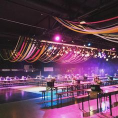 an empty dance floor is decorated with streamers and lights