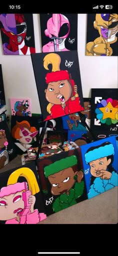 some cartoon paintings are on display in a room