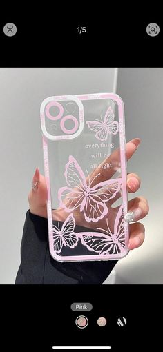 a person holding up a phone case with butterflies on the front and back cover in pink