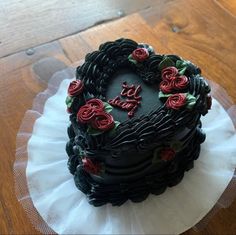 a heart shaped chocolate cake with roses on top