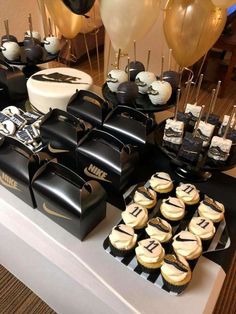 a table topped with lots of cakes and cupcakes