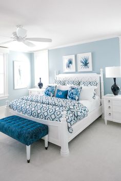 Bedroom with a light blue, royal blue and white color palette, patterned bedding, velvet ottoman, blue palm artwork, white wood bed frame, deep navy lamps, off-white carpet Greek Bedroom, Ocean City New Jersey, Beautiful Bedroom Designs, Blue Bedroom Decor, Ocean City Nj, Condo Interior, Bedroom Wall Designs, Tableau Design, Bedroom Bed Design