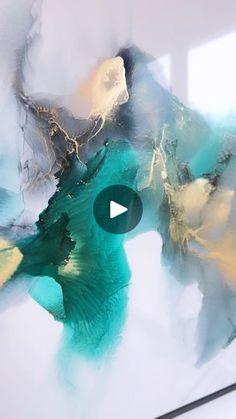 an abstract painting with blue, yellow and green colors on it's surface is featured in the video