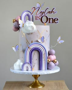 a birthday cake decorated with pastel colors and decorations