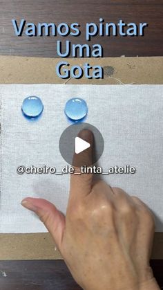 a person pointing at water droplets on a piece of paper with the words, vamos pintar una gota