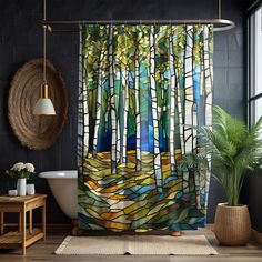 a bathroom with a shower curtain that has stained glass trees in the woods on it