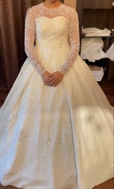 a woman in a white wedding dress posing for the camera