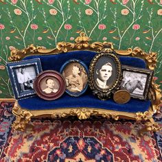 an ornate gold frame with three pictures on it and a blue velvet case in the foreground