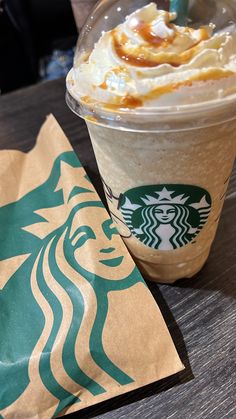 a starbucks drink with whipped cream and caramel on top