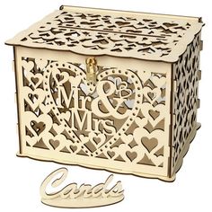 a wooden box with hearts and initials on it