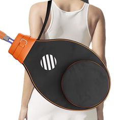 a woman is holding an orange and black object in her back pocket while wearing a white tank top