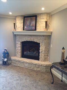 a living room with a stone fireplace in it