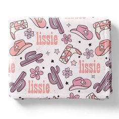 a pink and white blanket with hats, stars, and flowers on the bottom that says lisse aussie