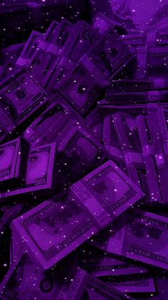 a pile of money sitting on top of a purple floor covered in stars and sparkles