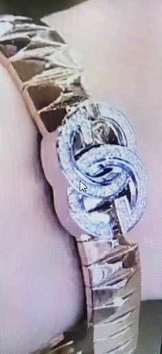 an image of a watch that appears to be made out of silver foil and diamonds