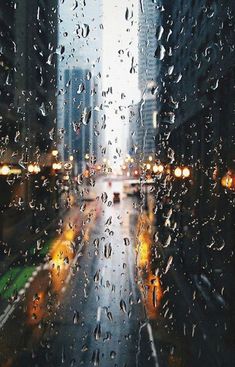 rain is falling on the windshield of a car