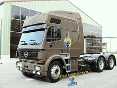 a large semi truck parked in front of a building