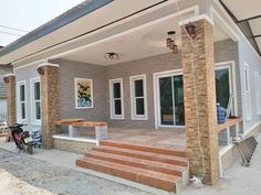 a house that has some steps leading up to the front door and side porch area