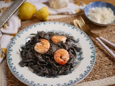 a plate of pasta with shrimp on it