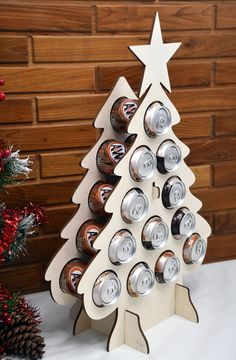 a christmas tree made out of cans with a star on top