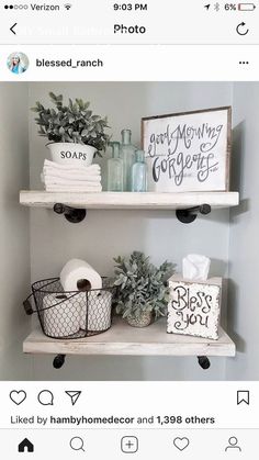 two shelves with toilet paper and other items on top of them, one shelf is white