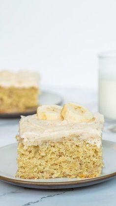 a piece of banana cake on a plate with a glass of milk in the background