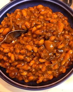 a bowl filled with baked beans on top of a table