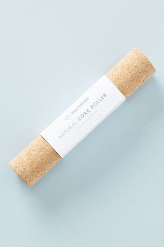 a roll of cork on a light blue background with the label in white and black