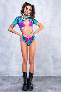 Rave and Festival Outfit Badinka. Form-fitting fest and rave bodysuit with unique designer print and vivid colors that do not fade away with washing. High quality material that makes you feel comfortable and sexy. 

 
 Mock Neckline 
 Robust and Hidden Back Zipper Closure 
 Short Sleeves 
 Crossed Straps Front 
 82% Polyester 18% Elastane 
 Non-Transparent Italian Lycra 
 30° Cold Wash, Hang dry 
 
 Sexy rave bodysuit, burning man clothing women, festival clothing, psychedelic clothing, pole dan Festival Outfit Women, Rave Bodysuit, Festival Outfits Women, Festival Outfits Rave, Strap Bodysuit, Outfits Rave, Burning Man Outfits, Cutout Bodysuit, Festival Clothing