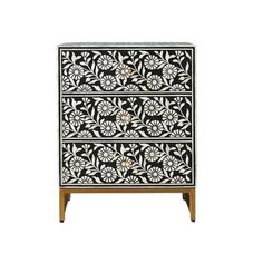 an ornate black and white cabinet with flowers on the front, two drawers and one door