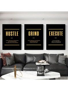 three black and gold posters on the wall above a gray couch in a living room