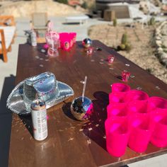 the table is set up with cups and other items on it for an outdoor party