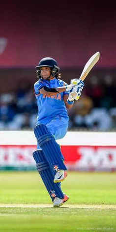 a man in blue uniform playing a game of cricket