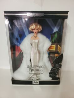 a barbie doll in a white dress and fur coat