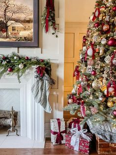 a decorated christmas tree in front of a fireplace