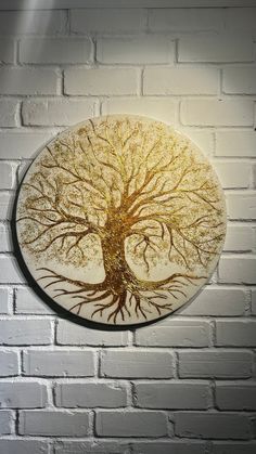 a white brick wall with a yellow and brown tree painted on it's side