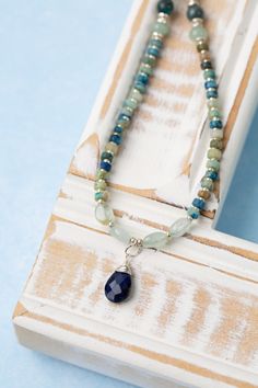 Indulge in the beauty of the sea with our Pacifica Collection! Each piece is meticulously handcrafted with stunning shades of blue, capturing the essence of ocean waves and clear skies. Sterling Silver (Lead & Nickel Free) Aquamarine, Jasper, Apatite, Lapis Lazuli 14.5-16.5" adjustable with sterling silver lobster claw clasp We hand select our natural materials, thus there may be slight variations in color and/or size that will not detract from the overall aesthetic. Our unique handcrafted designer jewelry for women is made in America, each design created individually in our personal design studio in Floyd, VA USA Blue Kyanite Gemstone Beaded Necklace, Blue Kyanite Gemstone Bead Necklaces, Artisan Blue Necklace With Gemstone Beads, Blue Aquamarine Briolette Necklace, Blue Kyanite Gemstone Beads Jewelry, Blue Kyanite Round Bead Jewelry, Blue Kyanite Jewelry With Gemstone Beads, Blue Kyanite Necklace For Gift, Blue Kyanite Gemstone Necklace